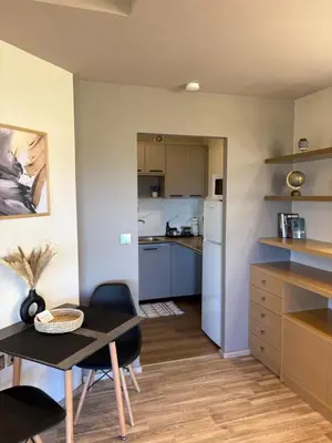 a small kitchen and dining room with a small table and chairs at Zen Luxury Studio in Kalamaki Chanion