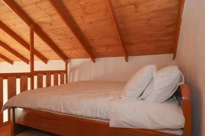 a bed in a room with wooden ceilings at Sternes house in Stérnai