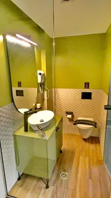 a bathroom with a sink and a mirror at GoldenRoyalSuites in Stalos