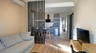 a living room with a white couch and a table at GoldenRoyalSuites in Stalos