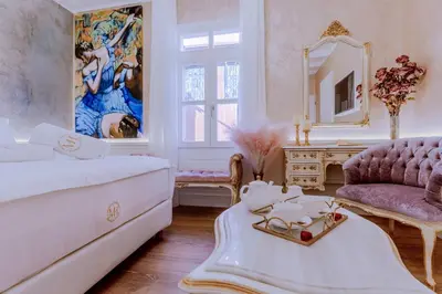a living room with a white bed and a mirror at Madame Hortense Boutique Ηotel in Chania Town