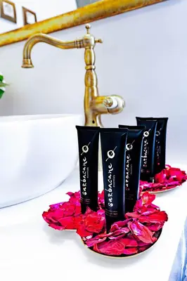 a group of three black toothbrushes inront of a mirror at Madame Hortense Boutique Ηotel in Chania Town