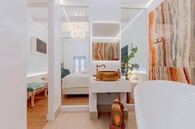 a white bathroom with a sink and a mirror at Madame Hortense Boutique Ηotel in Chania Town