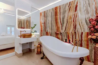 a white bathroom with a tub and a sink at Madame Hortense Boutique Ηotel in Chania Town
