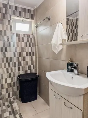 a bathroom with a sink and a shower at Mike's appartments in Chania Town