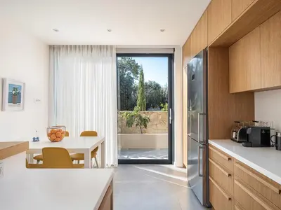 a kitchen with a table and a refrigerator at Villa Melista in Kounoupidhianá