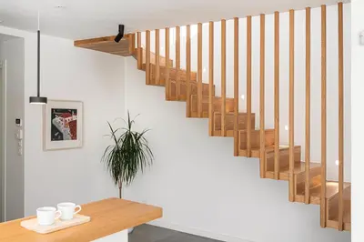 a wooden staircase in a room with a table at Villa Melista in Kounoupidhianá