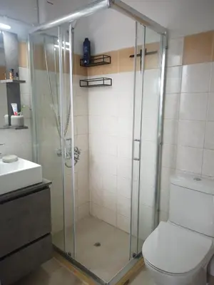 a bathroom with a shower with a toilet and a sink at Elysian Garden in Kalyves