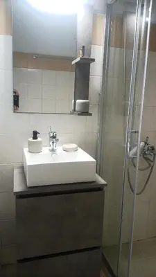 a bathroom with a white sink and a shower at Elysian Garden in Kalyves