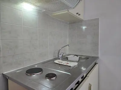 a kitchen with a sink with a faucet at Inna Rooms in Fournádhos