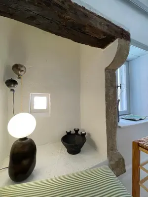 a bedroom with a bed and a lamp on the floor at Reas House in Chania Town