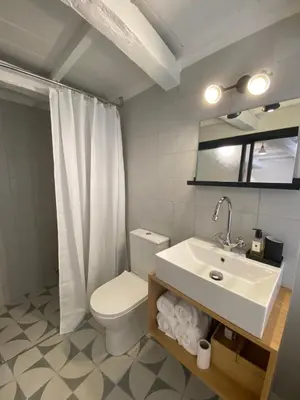 a bathroom with a sink and a toilet and a mirror at Reas House in Chania Town