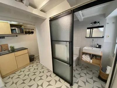 a kitchen with a glass door to a bathroom at Reas House in Chania Town
