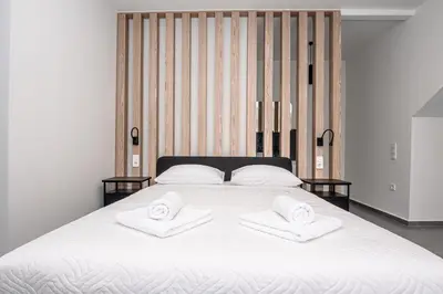 a large white bed with two towels on it at Tolis Exclusive Villa in Kissamos