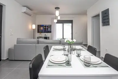 a living room with a table and a couch at Tolis Exclusive Villa in Kissamos