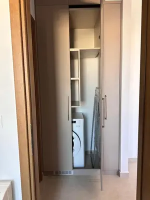 a closet with a washer and dryer in it at Etherio Urban Loft in Chania Town