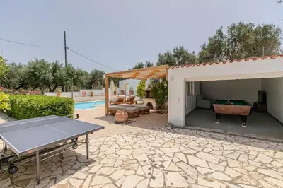 a backyard with a pool table and a pavilion at Villa Xamadochori in Xamoudhokhórion