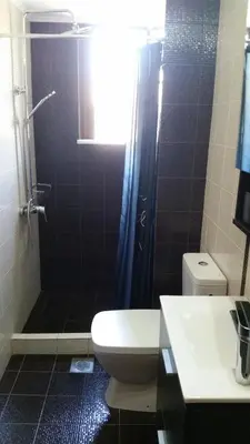 a bathroom with a shower and a toilet and a sink at Villa Ikaros in Kalamitsi Amygdali