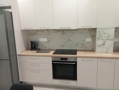 a kitchen with white cabinets and a stove at Golden Orb in Chania Town