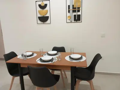 a dining room table with chairs and a wooden table at Golden Orb in Chania Town