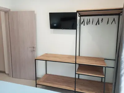 a book shelf with a television on a wall at Silver Orb in Chania Town