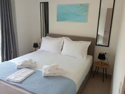 a bedroom with a bed with two towels on it at Silver Orb in Chania Town