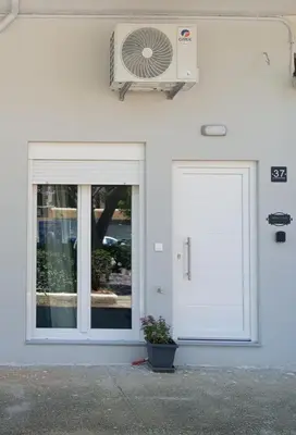 a white door with a fan on a building at Silver Orb in Chania Town