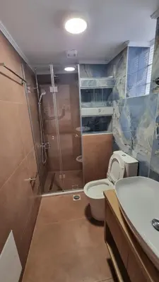 a bathroom with a shower and a toilet and a sink at Mairy's Apts Paleochora Mimagia in Palaiochóra