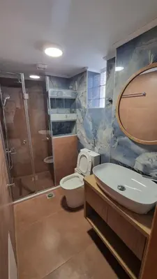 a bathroom with a toilet and a sink and a shower at Mairy's Apts Paleochora Mimagia in Palaiochóra