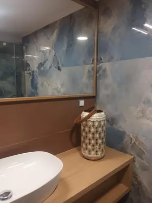 a bathroom with a toilet and a sink and a mirror at Mairy's Apts Paleochora Mimagia in Palaiochóra