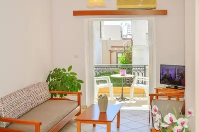 a living room with a couch and a table at Mairy's Apts Paleochora Mimagia in Palaiochóra