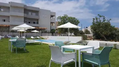 a group of tables and chairs next to a swimming pool at Kallimento in Kissamos