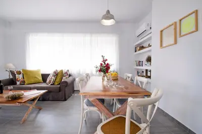 a living room with a wooden table and chairs at Kallimento in Kissamos