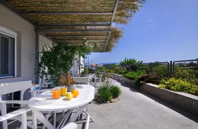 a white table with oranges on it on a patio at Kallimento in Kissamos