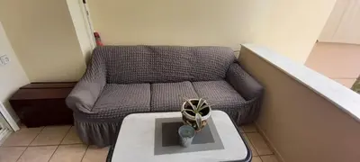 a living room with a couch and a table at Seaside apartment in Chania in Chania Town