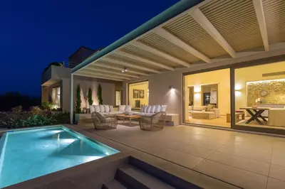 an outdoor patio with a swimming pool in a house at Villa Ianira in Kolymvari