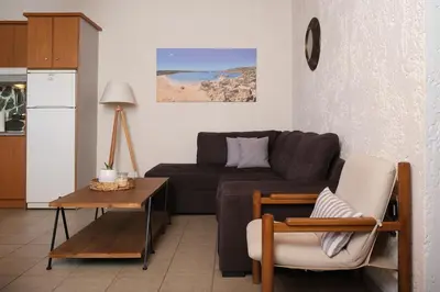 a living room with a couch and a table at Batilas House next to exotic beach of Elafonisi in Elafonisi