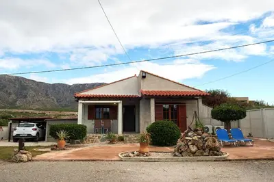 a house with chairs and a fountain in front of it at Batilas House next to exotic beach of Elafonisi in Elafonisi