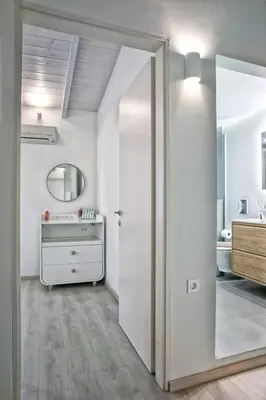 a bathroom with a mirror and a dressing room at Serena Residence in Chania Town
