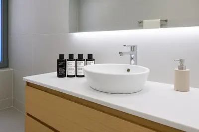 a bathroom with a sink and a white counter at Serena Residence in Chania Town