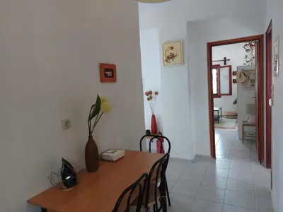 a dining room with a wooden table and chairs at Stavros Oak Tree House in Vasilópoulon