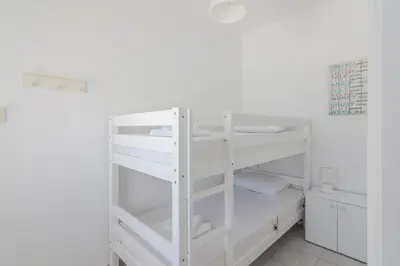 a white bunk bed in a white room at Stavros Oak Tree House in Vasilópoulon