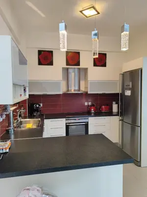 a kitchen with a sink and a refrigerator at Villa Anastasia Sissy in Módhion