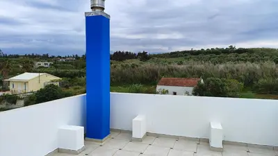 a blue pole sitting on top of a white wall at Villa Anastasia Sissy in Módhion