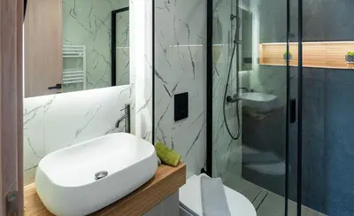 a bathroom with a white sink and a shower at Seascape Luxury Apartment 2 in Kounoupidhianá