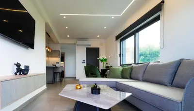a living room with a couch and a table at Seascape Luxury Apartment 2 in Kounoupidhianá