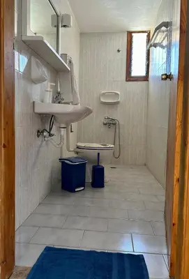 a bathroom with a sink and a toilet at BONATSA Rooms 2 in Palaiochóra