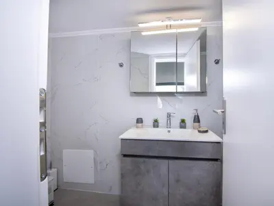 a bathroom with a sink and a mirror at Blue Balcony - Boutique Beachfront Suite with Private Parking Spot in Chania Town