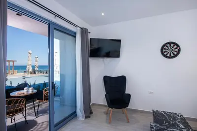 a living room with a view of the ocean at Blue Balcony - Boutique Beachfront Suite with Private Parking Spot in Chania Town