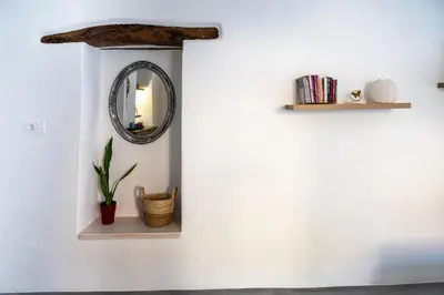 a mirror on a white wall with shelves and a plant at Casa Ellini unique & spacious by 8essentially in Kókkinos Pírgos